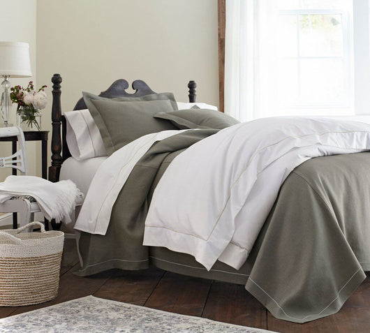Neutral linen bedding with contrasting satin stitch
