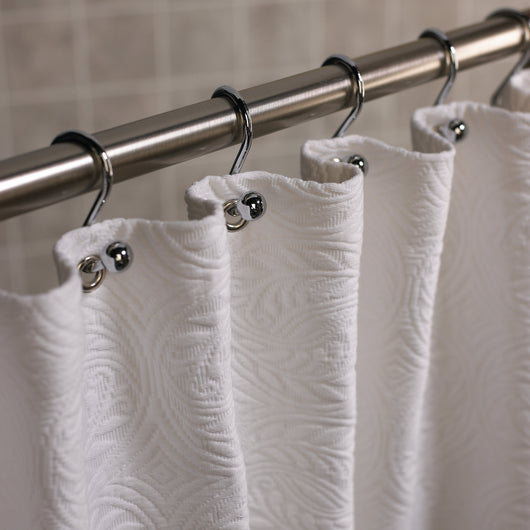 Detail of a white French medallion matelasse luxury shower curtain